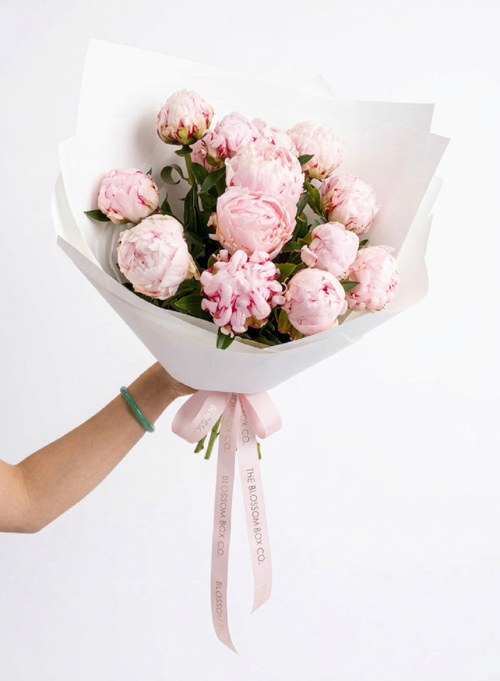 Pretty In Pink Peonies, a bunch of soft pink Sarah Bernhardt peonies in white wrap with a pink ribbon