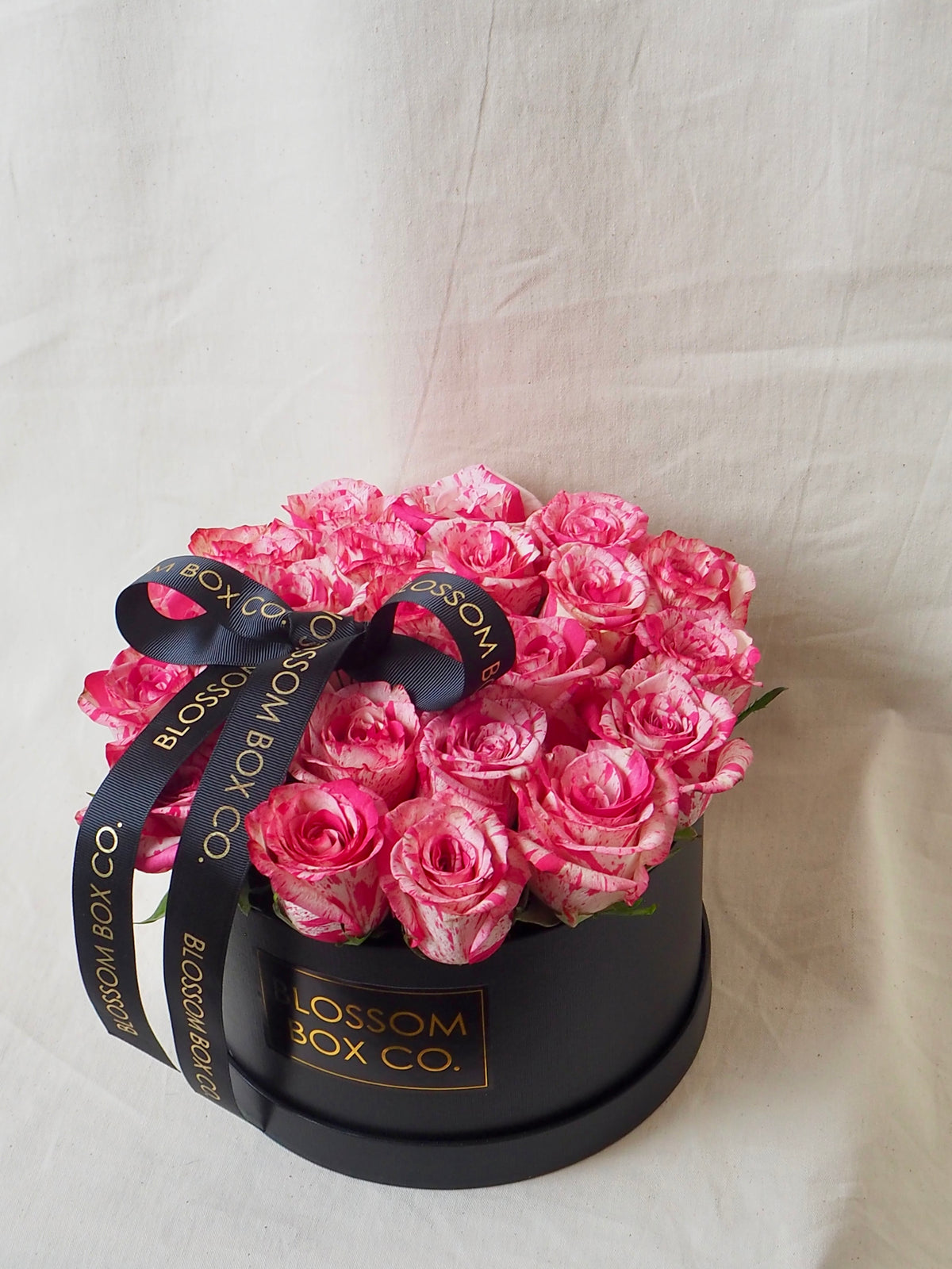 Rose Hat Box of pink roses in a black Blossom Box Co hat box with a ribbon, photo 1 of 6