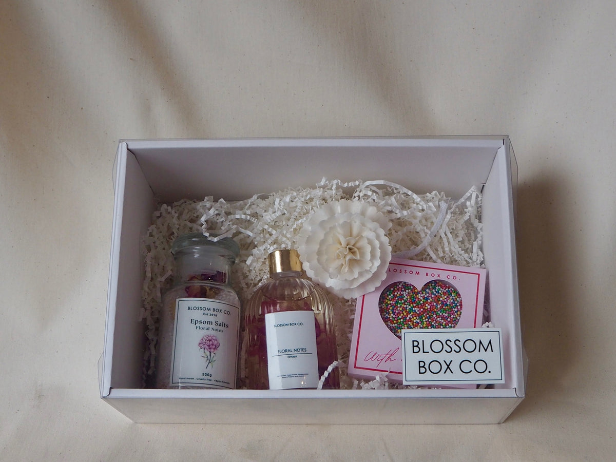 Treat Me Hamper opened, with bath salts, a reed diffuser and a freckle heart in a white box, photo 2 of 2